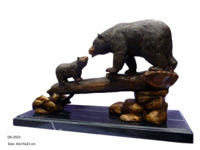 2 bronze bears on log