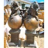 Pair of Bronze Lions on Bronze Ball with Marble Pedestals