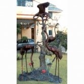 Four Bronze Cranes by a Tree